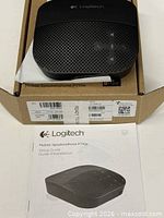 Speakerphone on top of original box with manual visible