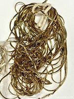 Coiled bundle of gold-tone braided necklaces