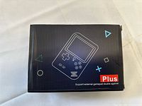 Front of retail box showing console graphic and Plus branding