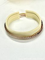 Bangle bracelet upright showing rose gold finish and pavé stones