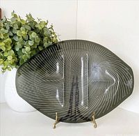 front view of smoky black glass tray on stand