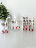 Full set showing pitcher and three tumblers with tricolor dots