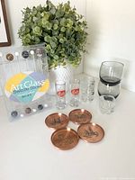 Group shot showing all swizzle sticks, coasters and shot glasses