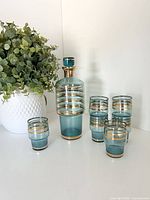 Full set showing decanter with stopper and five of the six glasses
