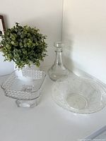 Overview of all three glass pieces: square pedestal compote, decanter, hobnail bowl