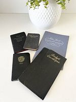 Group view of five vintage paper items including budget wallet, telephone book and three pocket notebooks