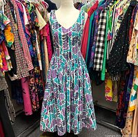 Dress on mannequin front view among clothing rack