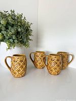 All four majolica pineapple mugs grouped front angle