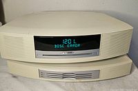 Front view showing main unit stacked on multi-CD changer, powered on display reads "DISC ERROR"
