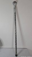 Full view of silver metal cane showing length and missing rubber tip