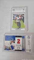 Full view of both graded cards in holders