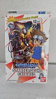 Front of sealed Starter Deck box showing artwork, title, signature, Bandai logo