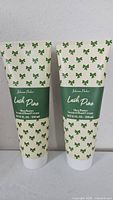 Front view of both sealed hand cream tubes
