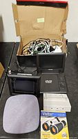 Entire lot showing speaker, DVD player, photo frame, power strips, binoculars and cables