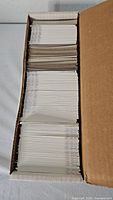 Long cardboard storage box filled with stacked football trading cards