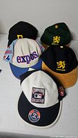 Group of five hats displayed
