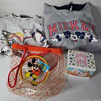 Group shot showing sweatshirt, T-shirt, tote bag, mug box