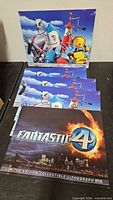 Stacked view showing three Robots lithographs and one Fantastic Four lithograph
