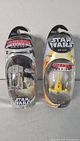 Front view of both sealed Star Wars Titanium Series packages