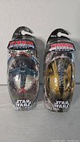 Front view of both sealed Titanium Series die-cast vehicles
