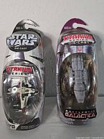 Front view of both sealed Titanium Series packages showing ARC-170 Starfighter and Battlestar Pegasus