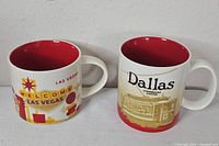Front view of both Dallas and Las Vegas mugs side by side