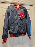 Full front view of navy satin Red Sox jacket on hanger