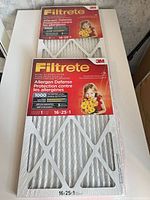 Two sealed 3M Filtrete air filters showing packaging details including size and MPR rating