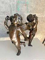 full view of two cherubs back-to-back showing overall form and finish