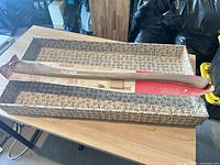Full view of new hickory axe handle in packaging