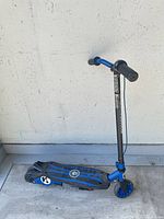 Full view of blue and black kids kick scooter upright