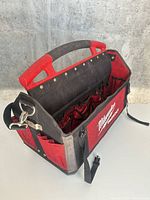 Open Milwaukee Packout tote showing interior pockets and tape clip
