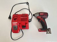 Milwaukee RapidCharge charger with cord and Milwaukee impact driver