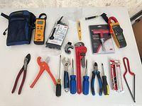 Overview of all nineteen tools and accessories laid out on white surface