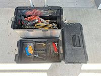 Toolbox open showing contents including heat gun, air hose, hand saws, and removable tray with hardware