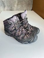 Side view of the pair of Salomon boots showing overall design and condition