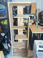 Front view of Structube tall wooden shelf showing staggered shelves and overall design