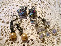 Three pairs of vintage earrings on crochet background