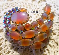 Front view of brooch showing satin glass cabochons and AB rhinestones