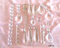 Full layout of all glass chandelier parts on pink cloth