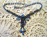 Full view of rhinestone necklace laid flat showing overall design and length
