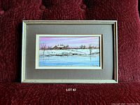 Front view of framed watercolor on sofa