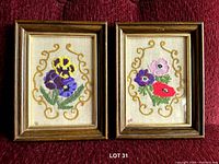 Both framed embroidery pieces side by side