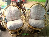 Front view of both rattan swivel chairs with cushions