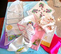 Group of towels, handkerchiefs and scarves spread on surface
