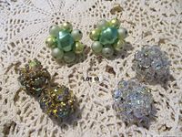 All three earring pairs laid out on lace background