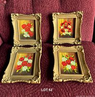 All four framed paintings on red upholstery