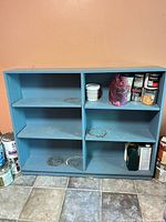 Front view of blue bookcase showing two columns and shelves