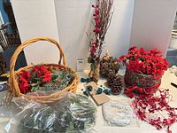 Overview of entire lot showing basket, greenery, garland, twig spray, pinecone ball, wreath form and bagged stems