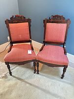 Front view of both Victorian chairs showing upholstery and overall design